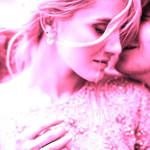 Pink monochrome image of attractive woman with pink hair leans to her man tender